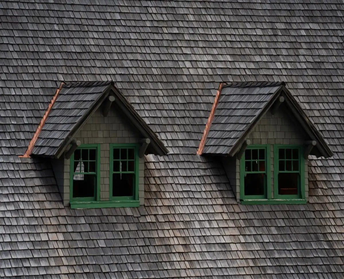 Dormers on a shingle roof in Jackson, MS, where step flashing and kickout flashing carry water past the walls