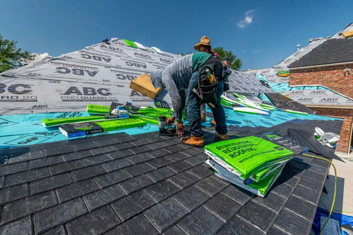 Roofer inspecting decking and underlayment on a residential roof in Jackson, MS